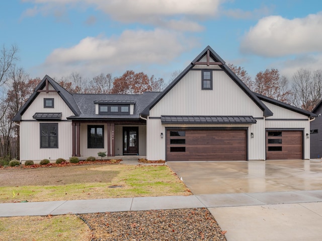 2750 Ashford Trl, Portage, MI 49024 - modern farmhouse with a standing seam roof, a garage, concrete driveway, roof with shingles, and a front lawn