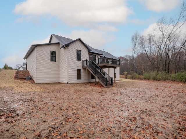 2750 Ashford Trl, Portage, MI 49024 - back of house featuring stairs, a wooden deck, and central air condition unit