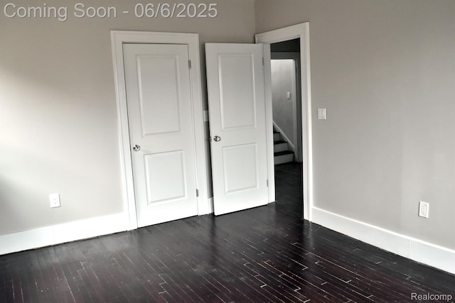 2054 Edison St, Detroit, MI 48206 - unfurnished bedroom with dark wood-style flooring and baseboards