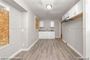 17167 Salem St, Detroit, MI 48219 - laundry area featuring wood finished floors and baseboards