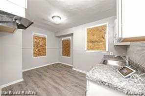17167 Salem St, Detroit, MI 48219 - kitchen with a sink, wood finished floors, white cabinets, and baseboards