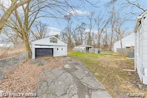 17167 Salem St, Detroit, MI 48219 - view of yard featuring a detached garage and an outbuilding