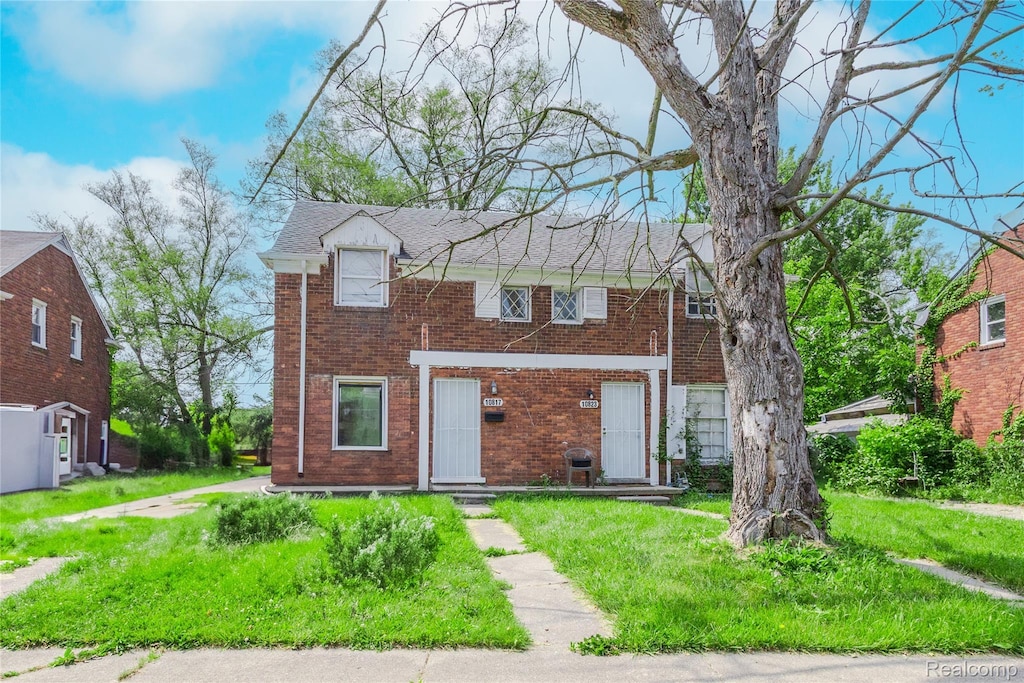 10817 Nottingham Rd, Detroit, MI 48224 - view of front facade featuring brick siding and a front yard