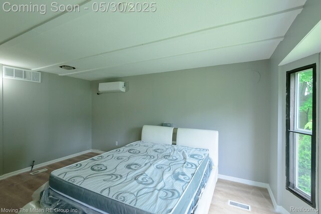 10531 Devils Lake Hwy, Addison, MI 49220 - bedroom with a wall unit AC, baseboards, and wood finished floors