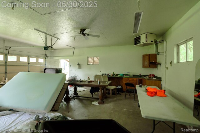 10531 Devils Lake Hwy, Addison, MI 49220 - garage with a heating unit, a garage door opener, and ceiling fan