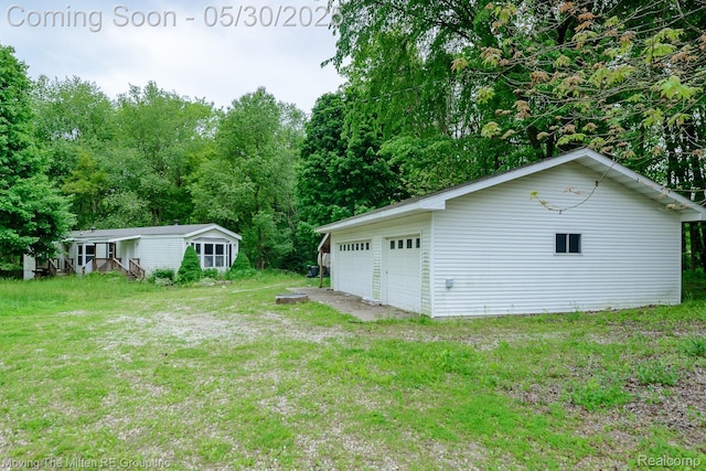 10531 Devils Lake Hwy, Addison, MI 49220 - view of grassy yard featuring a detached garage and an outbuilding