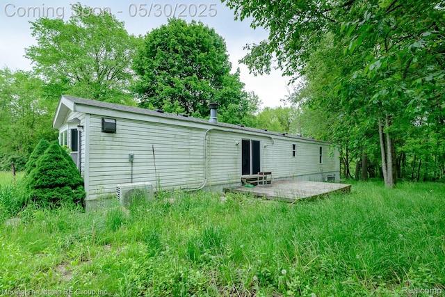 10531 Devils Lake Hwy, Addison, MI 49220 - rear view of house featuring a wooden deck and view of scattered trees