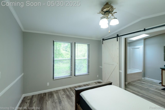 10531 Devils Lake Hwy, Addison, MI 49220 - bedroom with a barn door, wood finished floors, lofted ceiling, crown molding, and baseboards