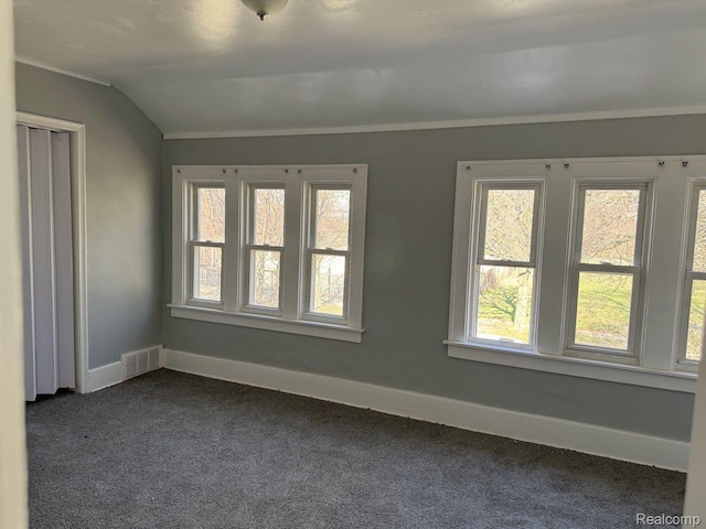 12632 E Canfield St, Detroit, MI 48215 - empty room featuring dark carpet, baseboards, plenty of natural light, crown molding, and lofted ceiling