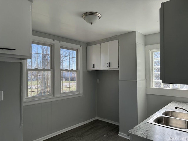 12632 E Canfield St, Detroit, MI 48215 - washroom featuring dark wood-style flooring, baseboards, and a sink