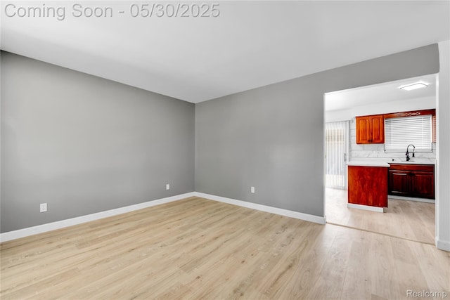 7278 Superior, Center Line, MI 48015 - unfurnished living room with a sink, light wood-type flooring, and baseboards