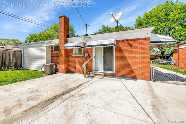 7278 Superior, Center Line, MI 48015 - rear view of property featuring central AC unit, brick siding, a patio, and a chimney