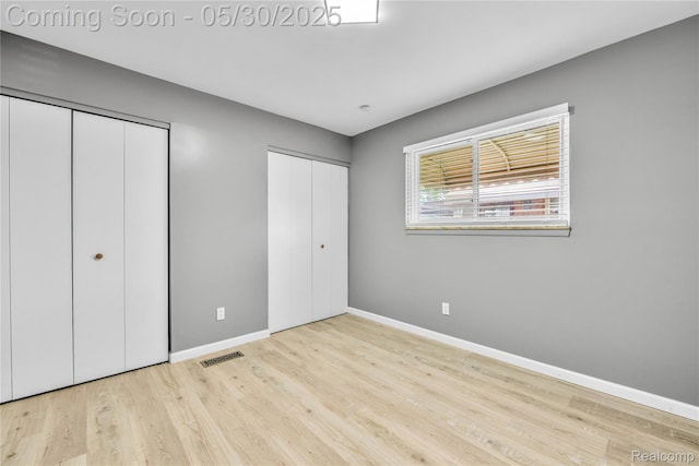 7278 Superior, Center Line, MI 48015 - unfurnished bedroom with multiple closets, baseboards, and wood finished floors