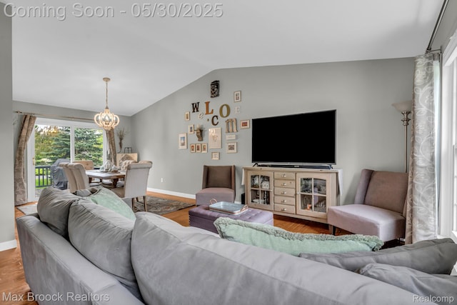 591 S Spinningwheel Ln, Bloomfield Hills, MI 48304 - living room featuring lofted ceiling, a chandelier, baseboards, and wood finished floors