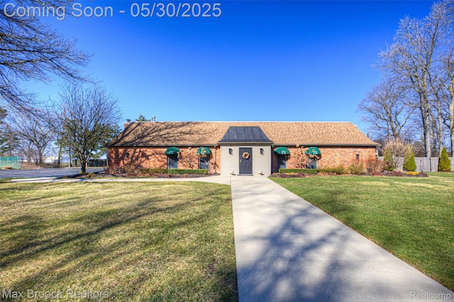 591 S Spinningwheel Ln, Bloomfield Hills, MI 48304 - view of front facade with a front lawn, a shingled roof, and brick siding