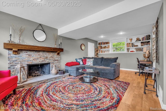 591 S Spinningwheel Ln, Bloomfield Hills, MI 48304 - living room with wood finished floors, a fireplace, and baseboards
