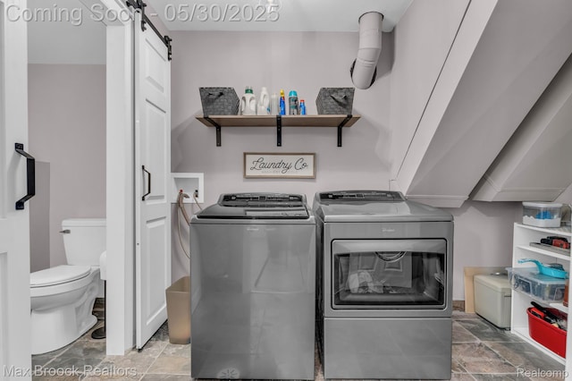591 S Spinningwheel Ln, Bloomfield Hills, MI 48304 - washroom with washer and clothes dryer, a barn door, and light stone finish floors