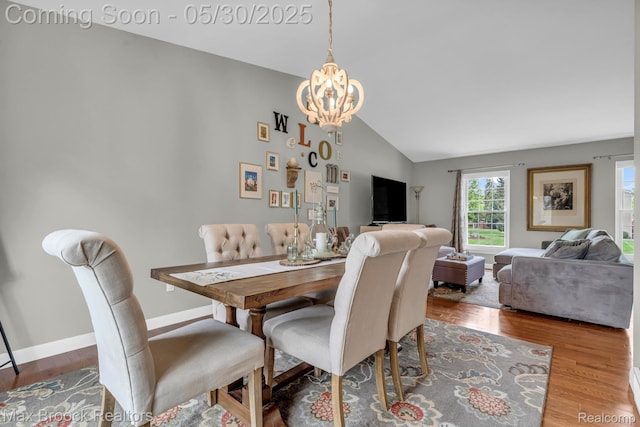 591 S Spinningwheel Ln, Bloomfield Hills, MI 48304 - dining area featuring vaulted ceiling, a chandelier, wood finished floors, and baseboards