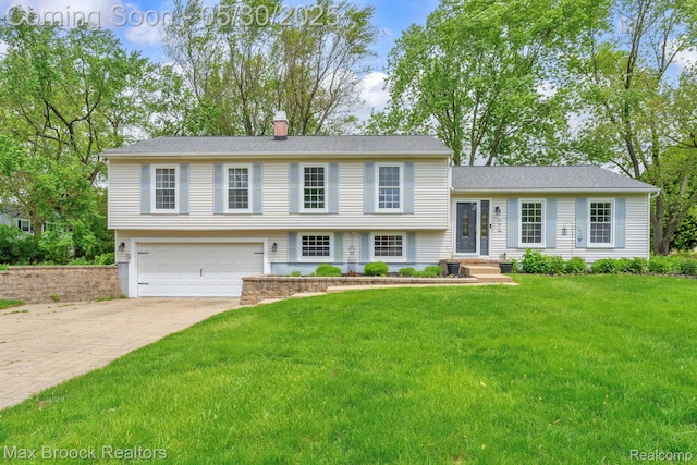 591 S Spinningwheel Ln, Bloomfield Hills, MI 48304 - tri-level home featuring a garage, driveway, a chimney, and a front lawn