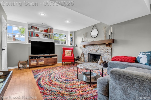 591 S Spinningwheel Ln, Bloomfield Hills, MI 48304 - living area with a fireplace, hardwood / wood-style floors, baseboards, plenty of natural light, and recessed lighting