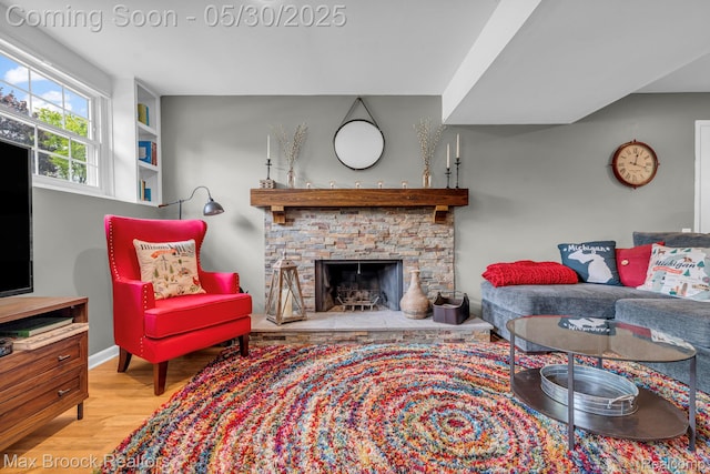 591 S Spinningwheel Ln, Bloomfield Hills, MI 48304 - living room with wood finished floors, a fireplace, and baseboards