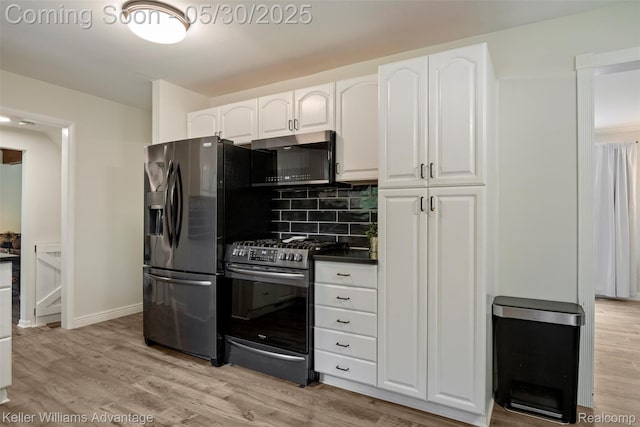 23355 Larkshire St, Farmington Hills, MI 48336 - kitchen with black microwave, stainless steel gas stove, fridge with ice dispenser, tasteful backsplash, and white cabinetry