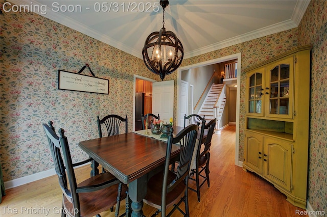 7730 Parkcrest Cir, Clarkston, MI 48348 - dining area with a chandelier, stairway, light wood finished floors, wallpapered walls, and ornamental molding