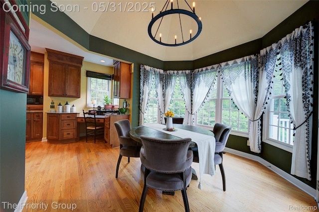 7730 Parkcrest Cir, Clarkston, MI 48348 - dining room with a chandelier, healthy amount of natural light, light wood finished floors, and lofted ceiling