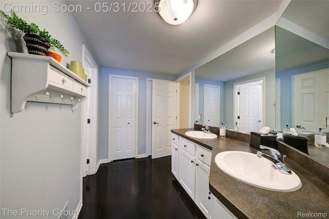 7730 Parkcrest Cir, Clarkston, MI 48348 - full bathroom with double vanity, wood finished floors, and baseboards