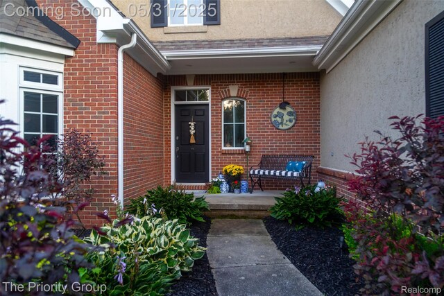 7730 Parkcrest Cir, Clarkston, MI 48348 - doorway to property with brick siding and stucco siding