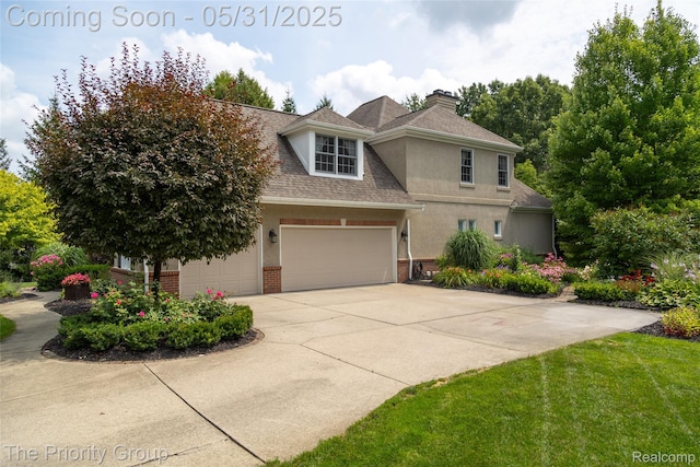 7730 Parkcrest Cir, Clarkston, MI 48348 - view of front of home with brick siding, a chimney, stucco siding, driveway, and a garage