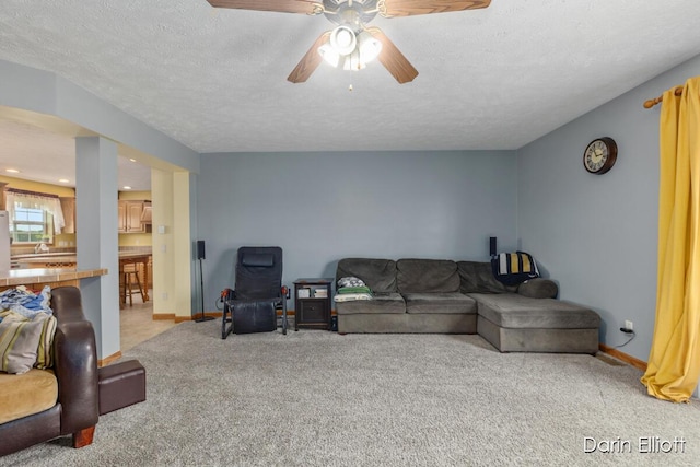 1141 E Tupper Lake Rd, Lake Odessa, MI 48849 - living area with light colored carpet, a ceiling fan, baseboards, a textured ceiling, and recessed lighting