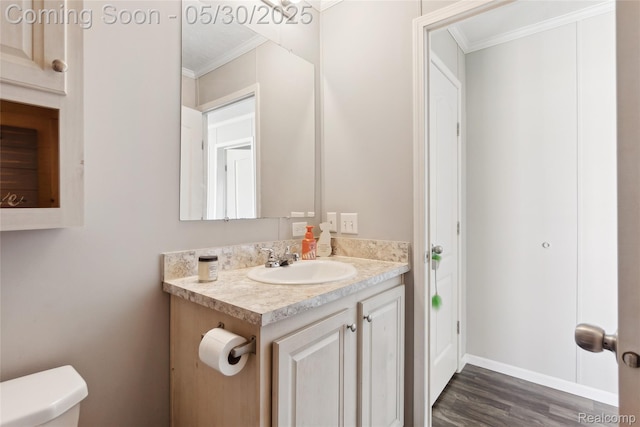 29 Fox Hound Ct, Grand Blanc, MI 48439 - bathroom featuring crown molding, vanity, toilet, wood finished floors, and baseboards