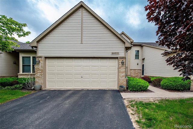 24511 Pinehurst Ave Unit 14, Oak Park, MI 48237 - view of front of house with brick siding, driveway, and an attached garage