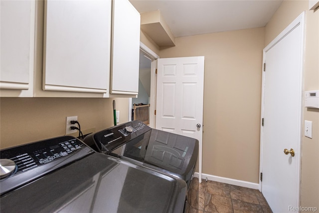 24511 Pinehurst Ave Unit 14, Oak Park, MI 48237 - washroom with cabinet space, washer and dryer, baseboards, and dark stone finish floors