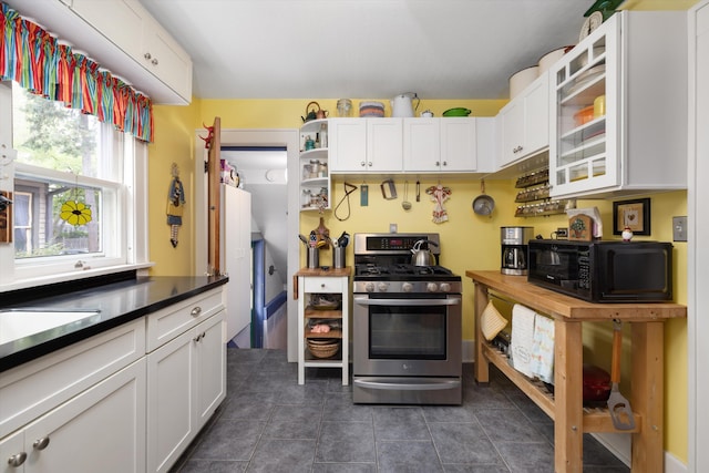 708 S Laurel St, Royal Oak, MI 48067 - kitchen featuring stainless steel gas range oven, black microwave, open shelves, white cabinetry, and dark countertops