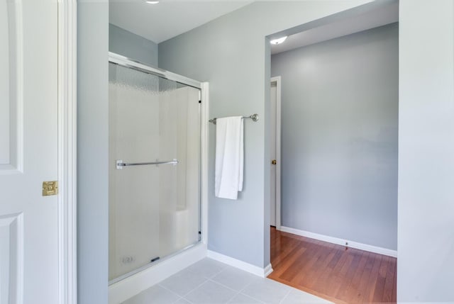 3352 Hampstead Ct, Portage, MI 49024 - full bath featuring a stall shower, baseboards, and wood finished floors