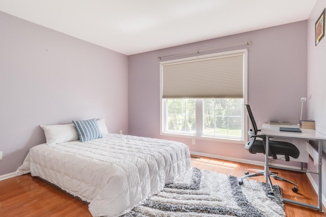 3352 Hampstead Ct, Portage, MI 49024 - bedroom with wood finished floors, baseboards, and an office area