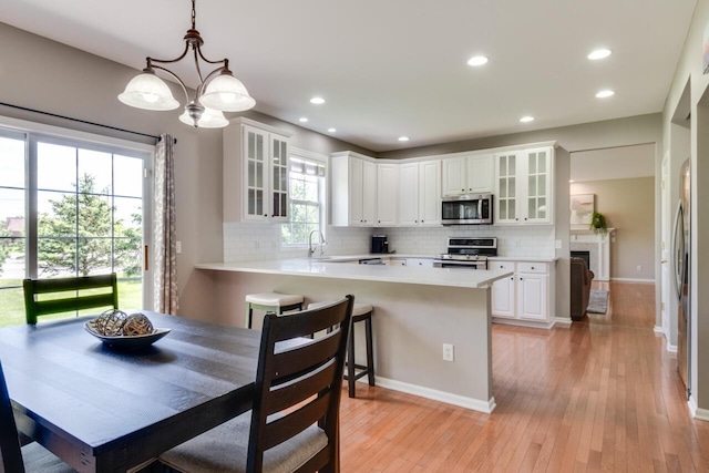 3352 Hampstead Ct, Portage, MI 49024 - kitchen with stainless steel appliances, a chandelier, light countertops, decorative backsplash, and recessed lighting