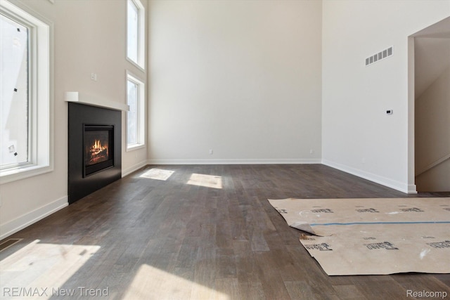 2911 Walsh Dr, Rochester Hills, MI 48309 - unfurnished living room with wood finished floors, a glass covered fireplace, and baseboards