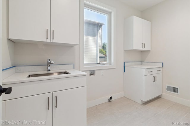 2911 Walsh Dr, Rochester Hills, MI 48309 - washroom featuring hookup for a washing machine, baseboards, cabinet space, and light tile patterned flooring