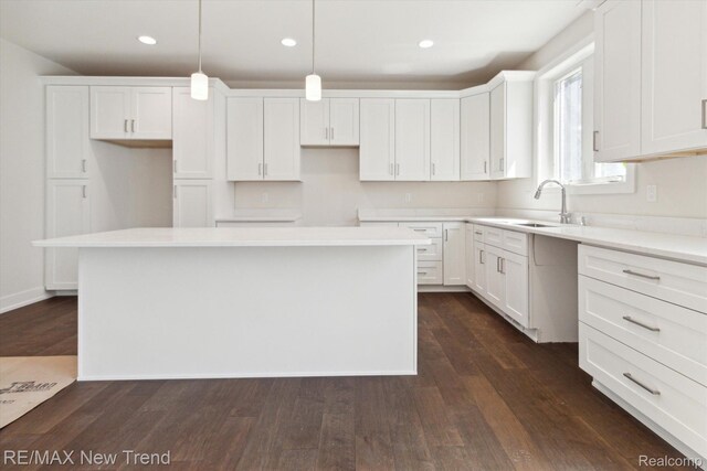 2911 Walsh Dr, Rochester Hills, MI 48309 - kitchen with a sink, white cabinets, dark wood-style floors, a center island, and recessed lighting