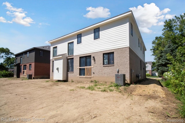 2911 Walsh Dr, Rochester Hills, MI 48309 - rear view of house featuring brick siding and central AC unit