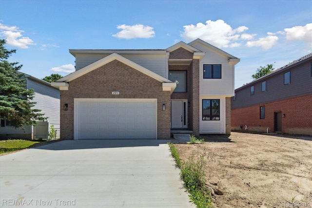 2911 Walsh Dr, Rochester Hills, MI 48309 - view of front facade with brick siding, an attached garage, and concrete driveway
