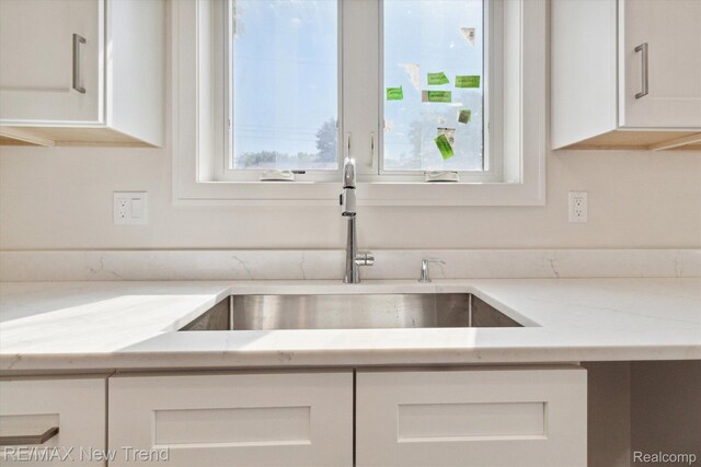 2911 Walsh Dr, Rochester Hills, MI 48309 - kitchen with a sink, white cabinets, plenty of natural light, and light stone counters