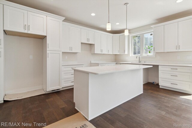 2911 Walsh Dr, Rochester Hills, MI 48309 - kitchen featuring recessed lighting, dark wood-style flooring, white cabinets, a center island, and a sink