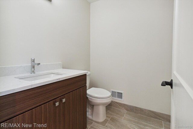 2911 Walsh Dr, Rochester Hills, MI 48309 - half bathroom with toilet, vanity, and tile patterned floors