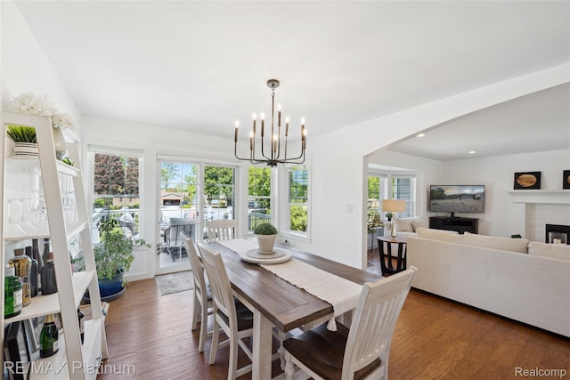 13368 Fenton Rd, Fenton, MI 48430 - dining area featuring healthy amount of natural light, wood finished floors, a chandelier, arched walkways, and recessed lighting
