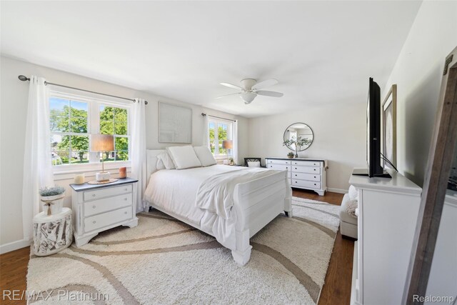 13368 Fenton Rd, Fenton, MI 48430 - bedroom with wood finished floors, ceiling fan, and baseboards