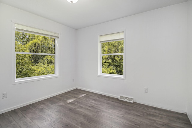 7929 N 48th St, Augusta, MI 49012 - spare room featuring dark wood-type flooring and baseboards